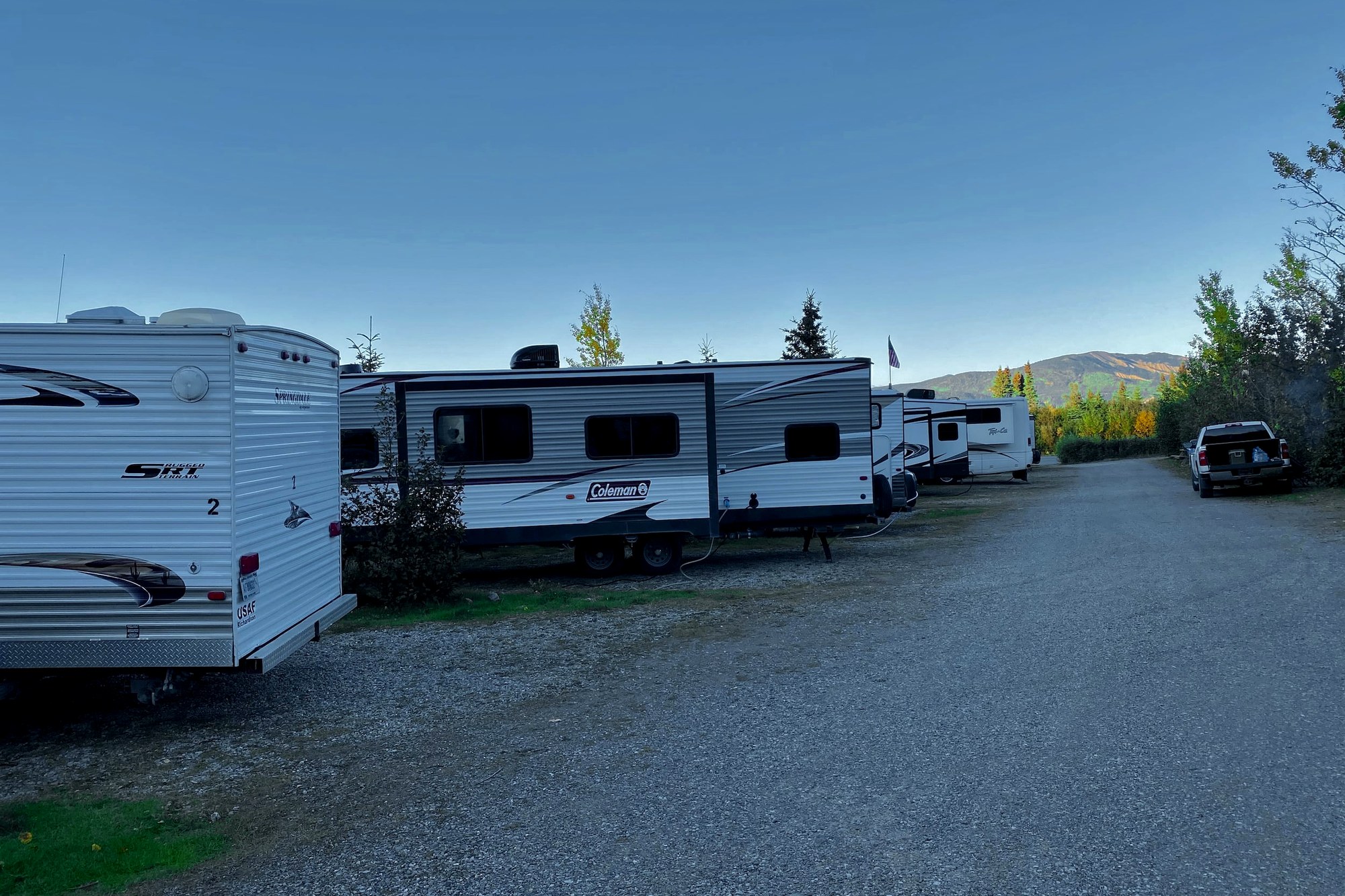 Row of RV sites with Alaska Range mountains behind at Denali Hotel & RV Village